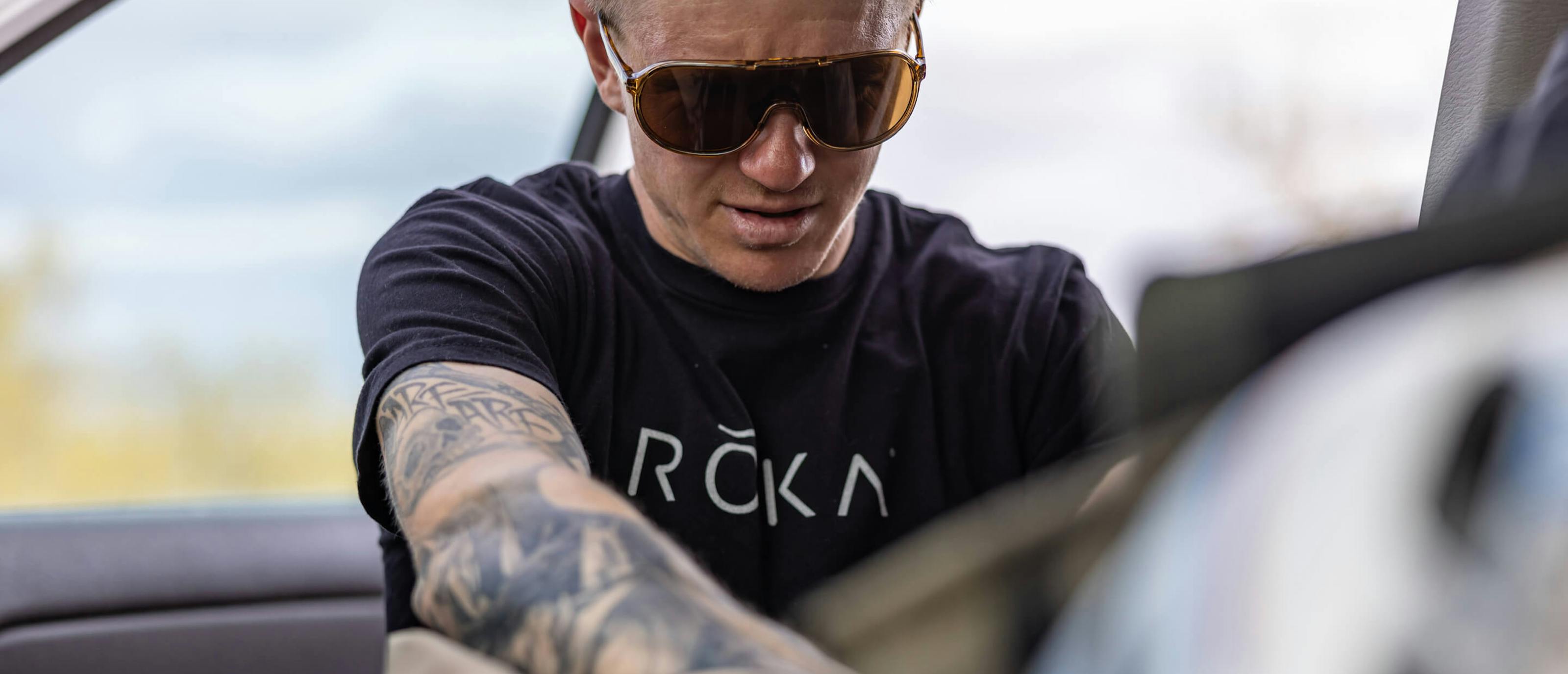 Man in sunglasses and black ROKA T-Shirt