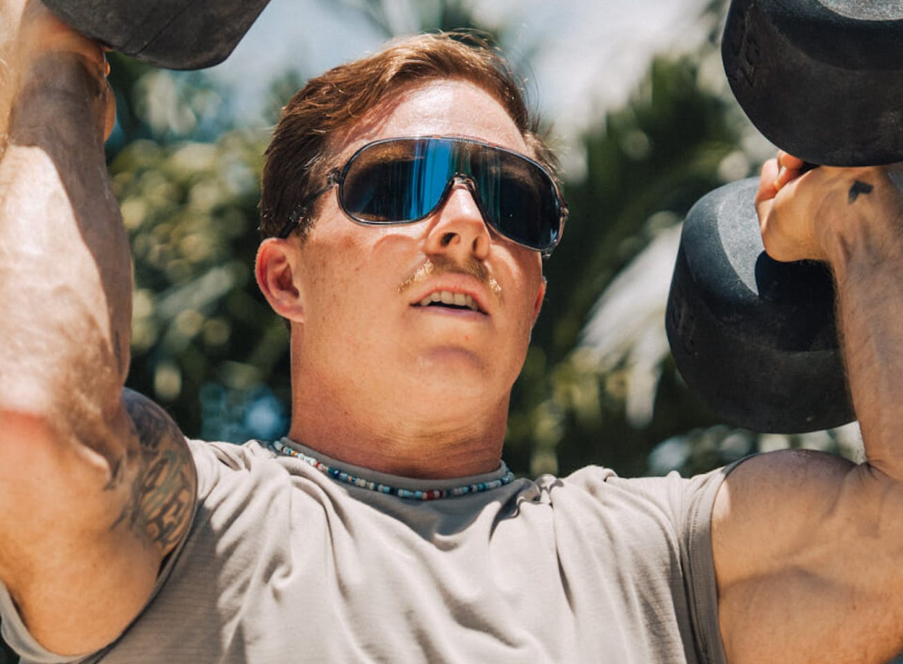 Man lifting dumbells in San Remo Sunglasses