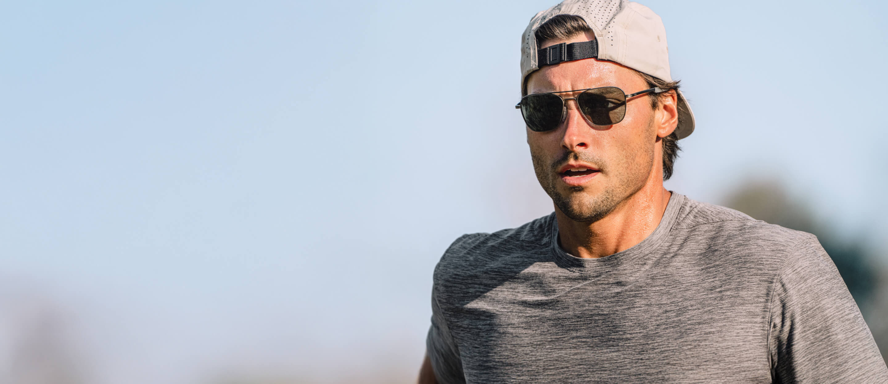 Man running in backwards hat and Falcon sunglasses