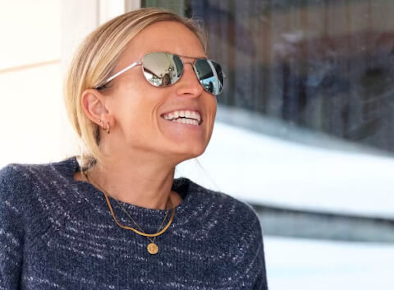 Woman Smiling in Rio Sunglasses