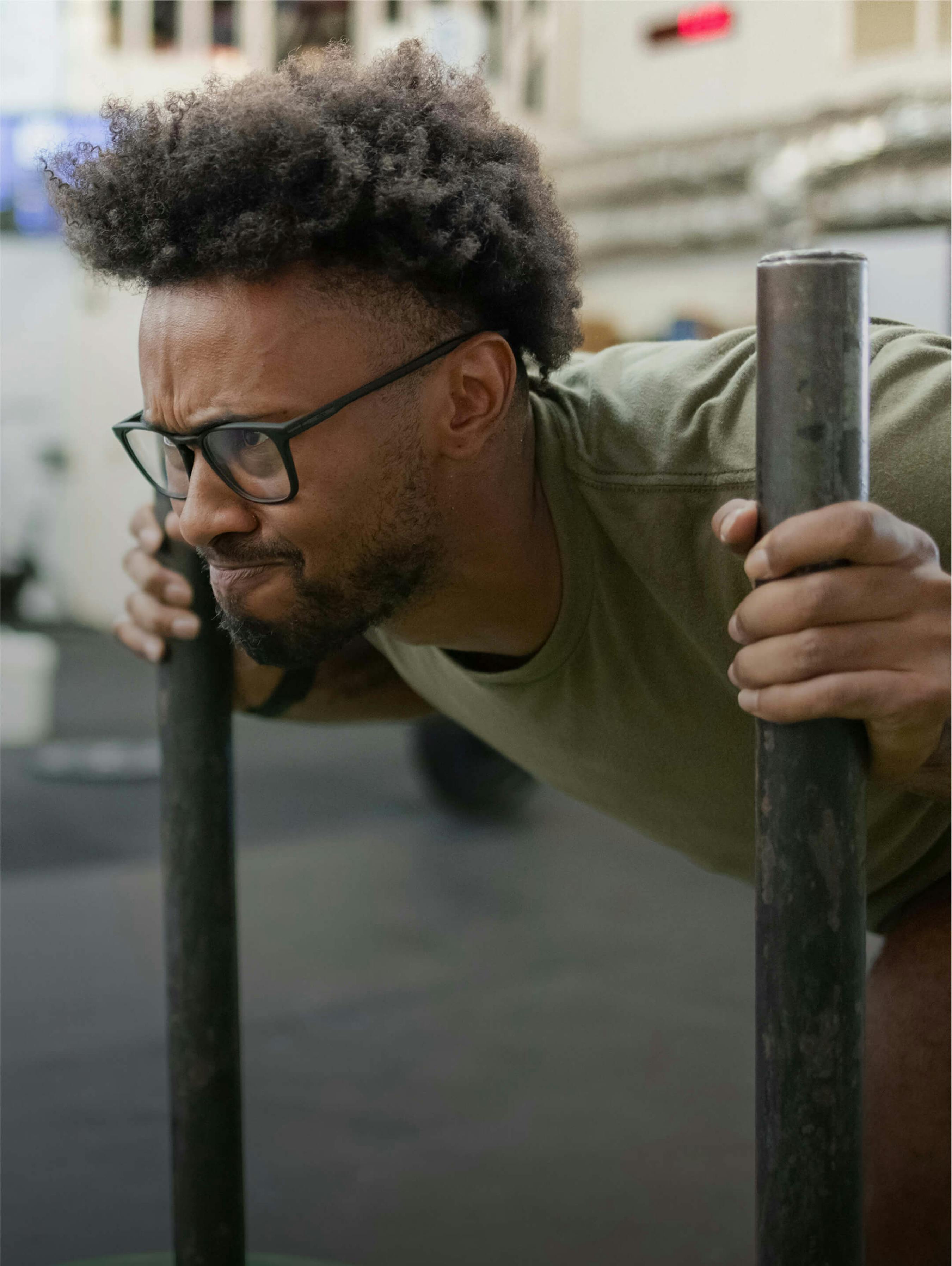 Man pushing weighted sled