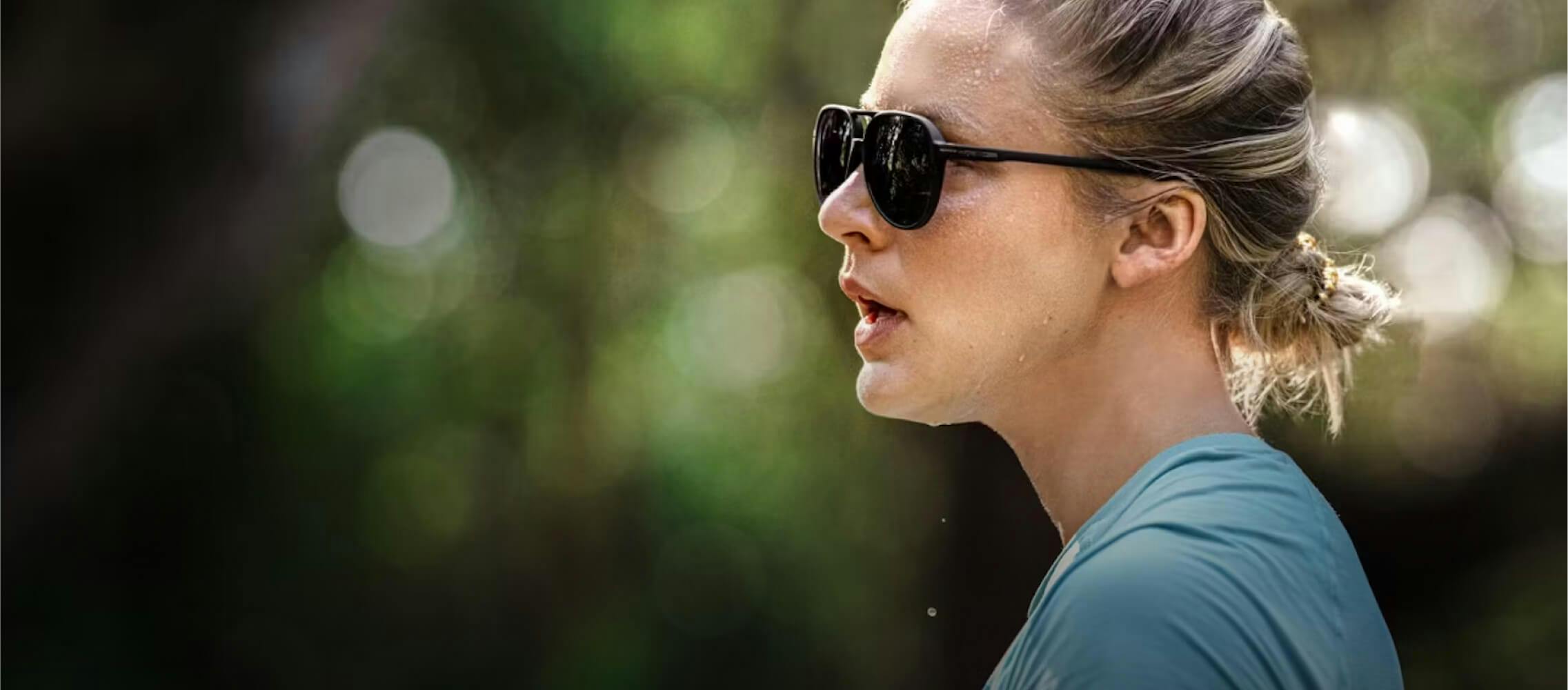 Woman in blue shirt and Havana sunglasses