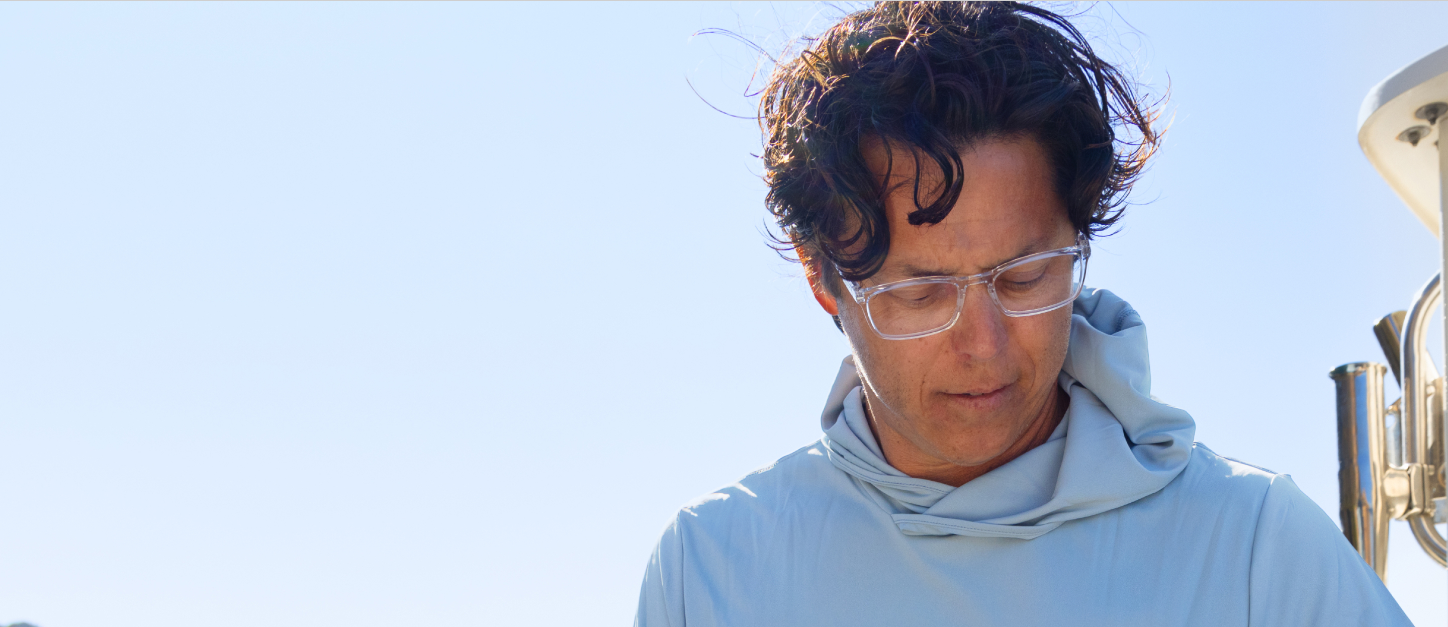 Man in blue shirt and Palmer eyeglasses