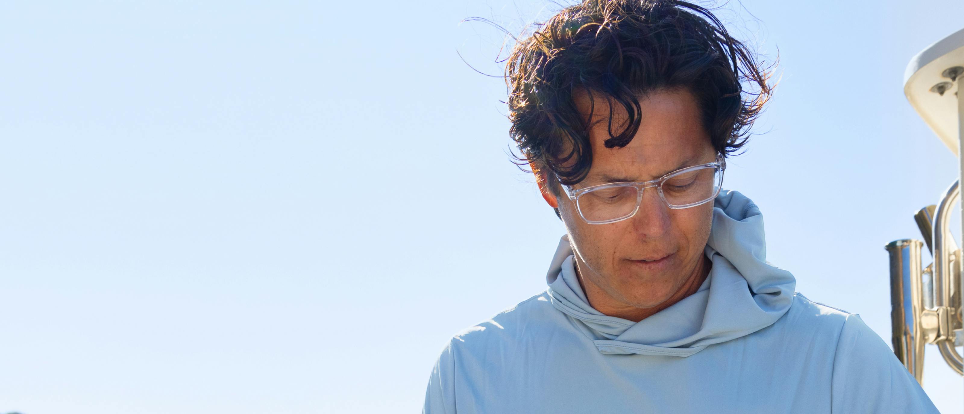Man in blue shirt and Palmer eyeglasses
