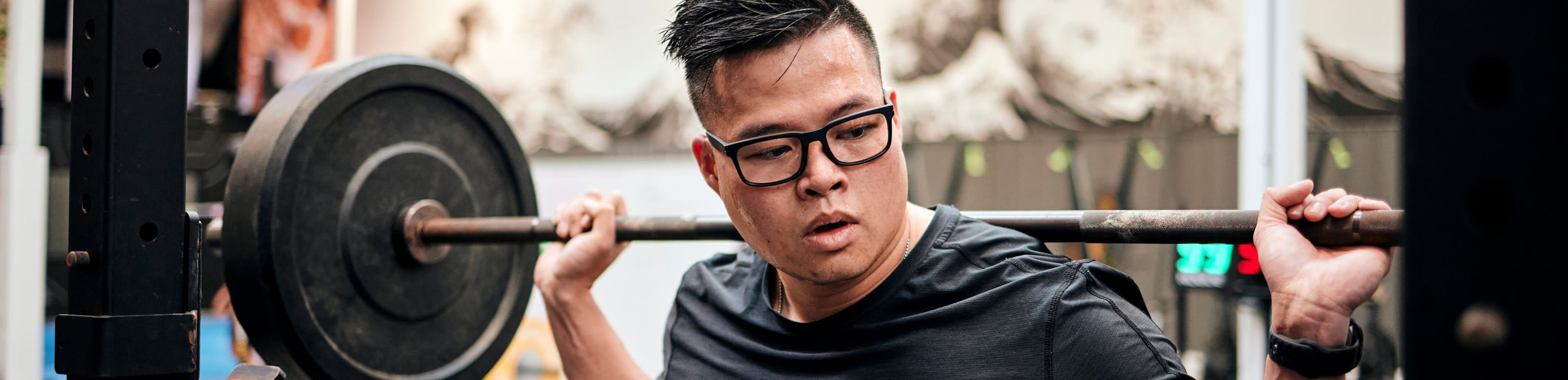 Man squatting in Braker eyeglasses