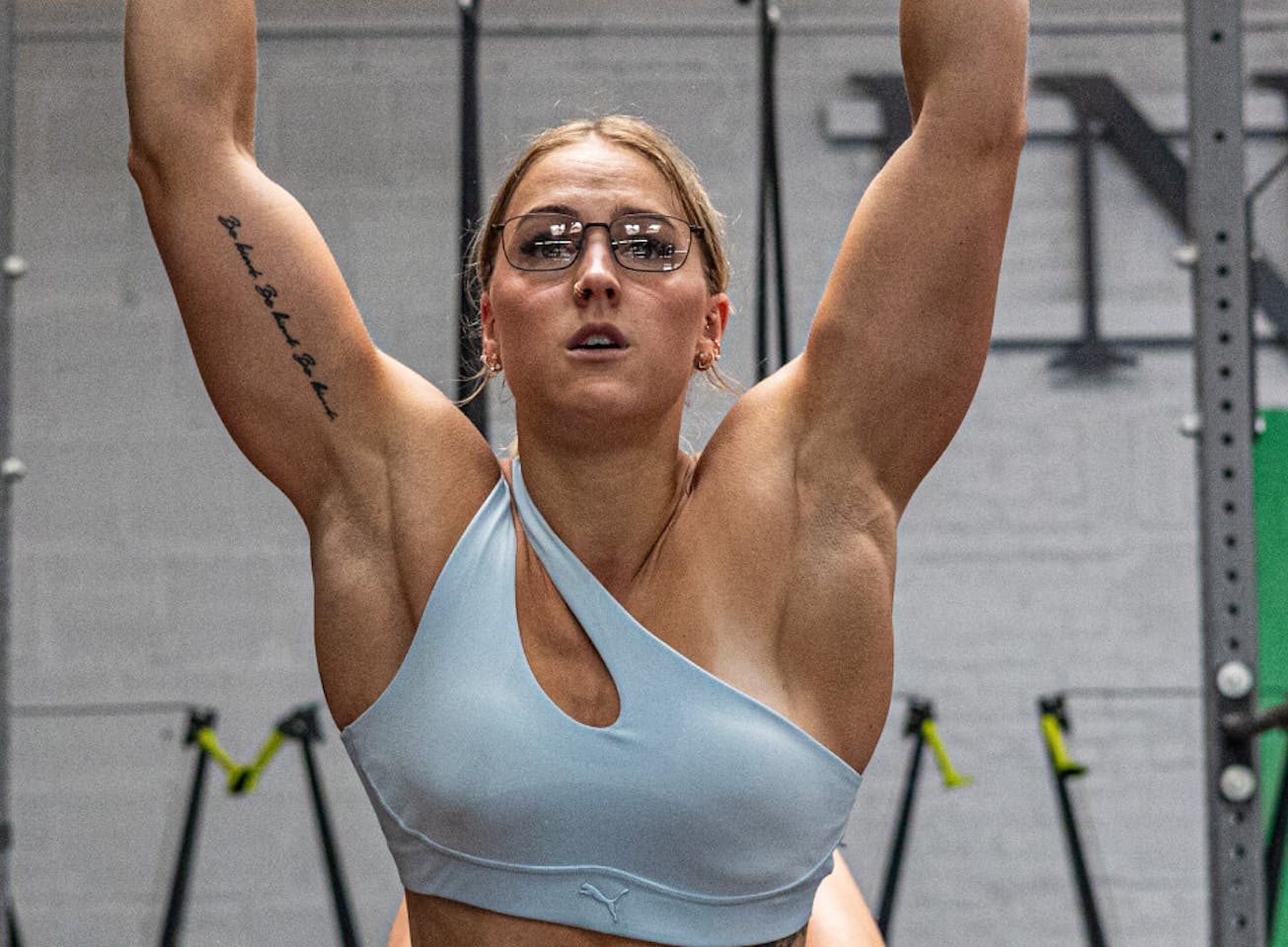 Woman doing pull up in Vapor eyeglasses