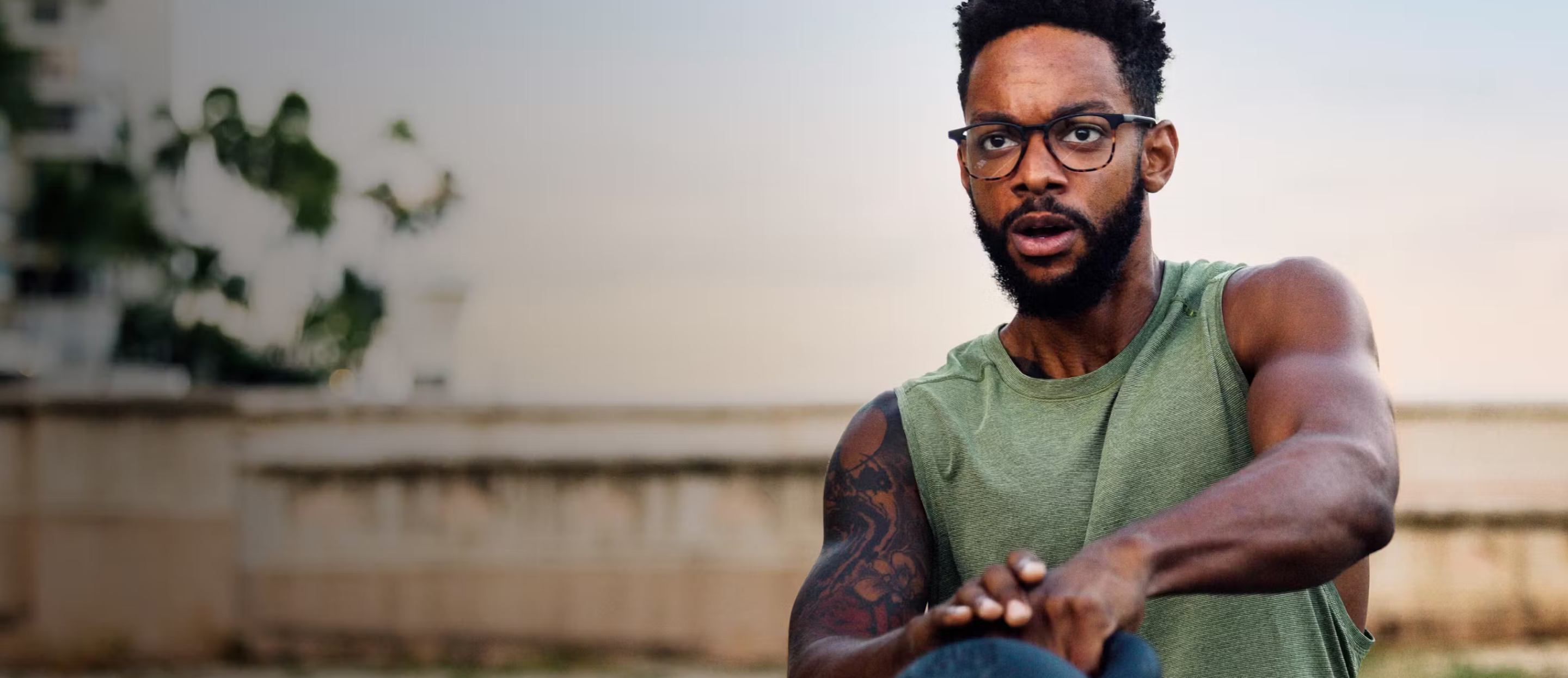 Man swinging kettlebell wearing Hunter eyeglasses