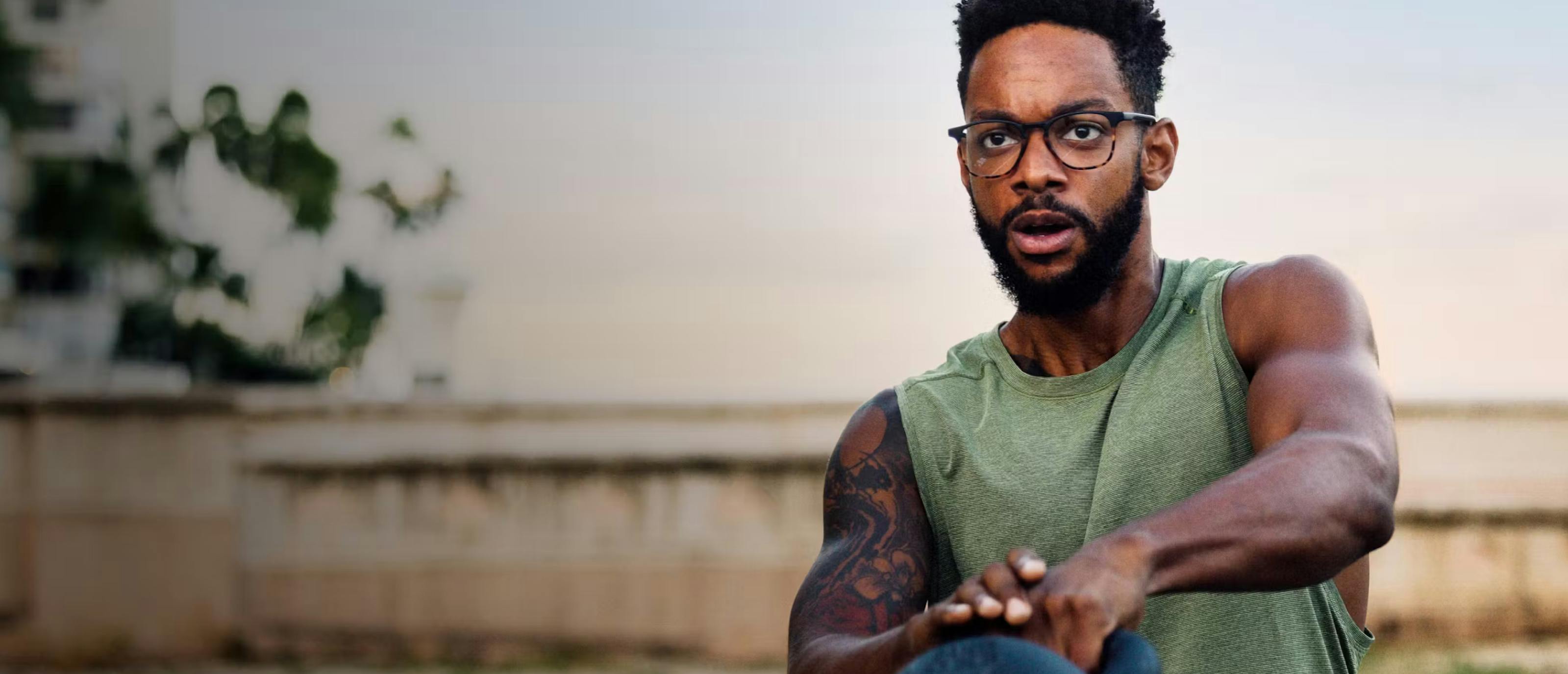 Man swinging kettlebell wearing Hunter eyeglasses