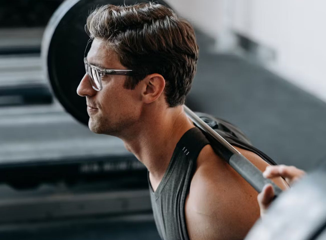 Man squatting in Barton eyeglasses