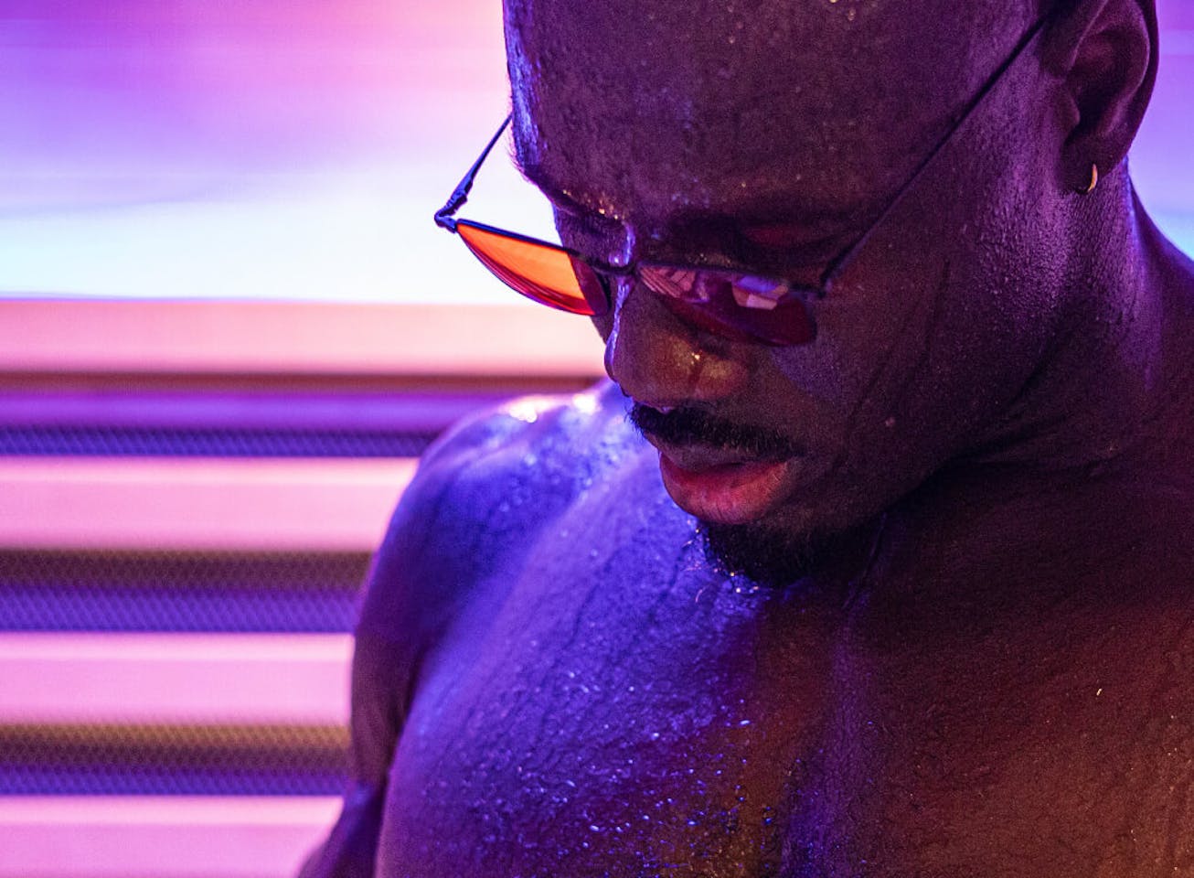 Man wearing vapor wind down glasses looking at phone