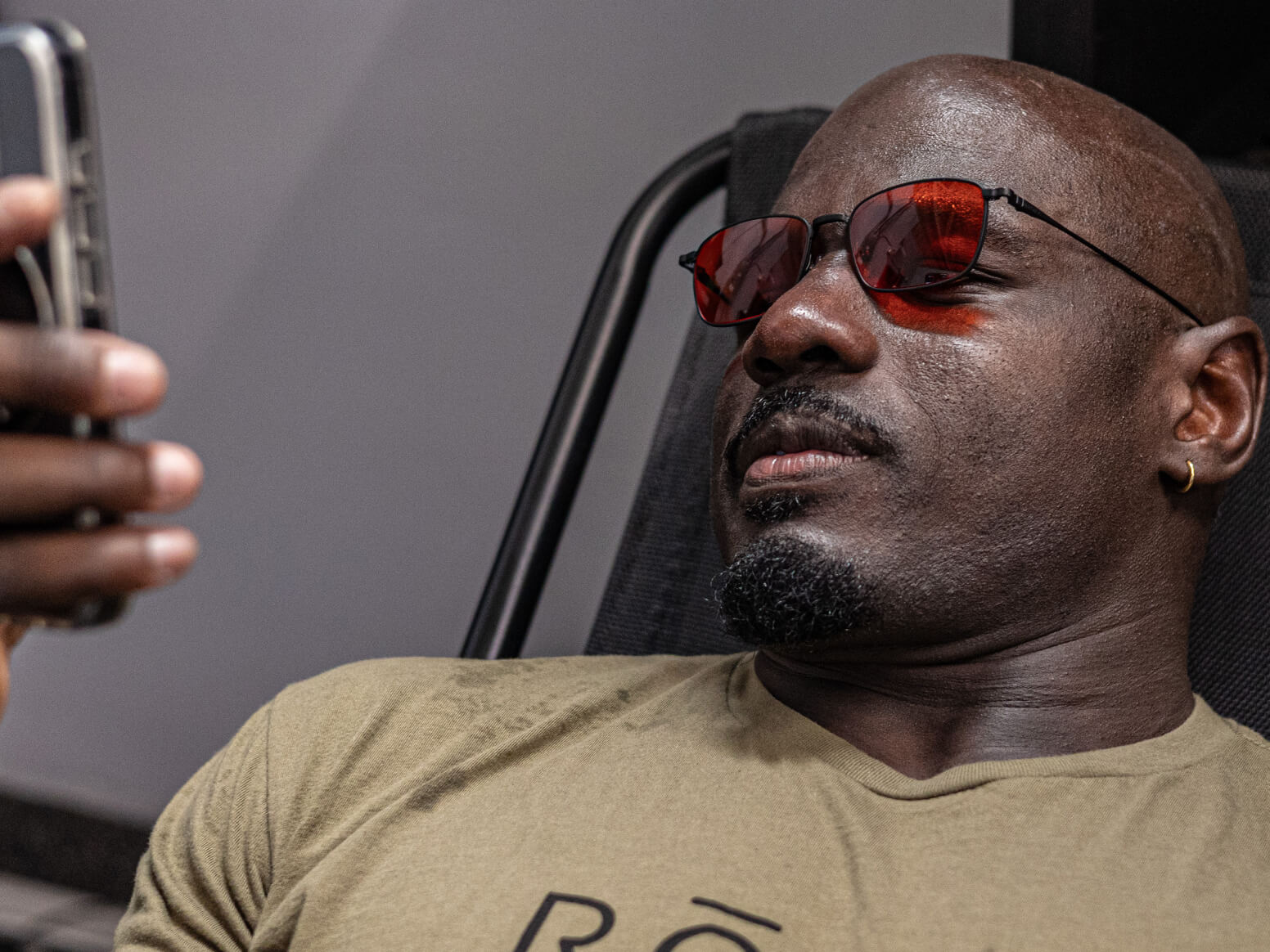 Man wearing vapor wind down glasses looking at phone