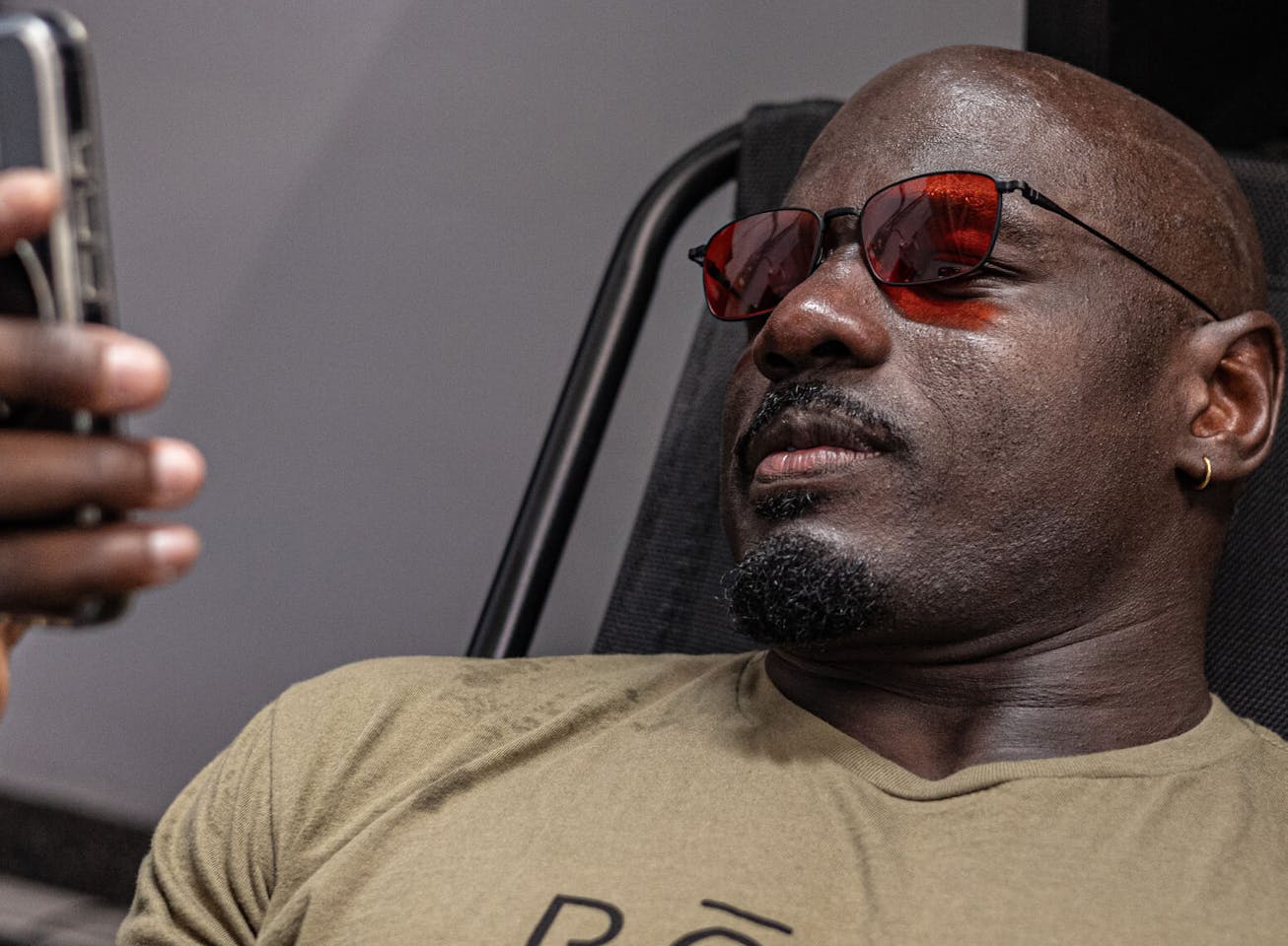 Man wearing vapor wind down glasses looking at phone