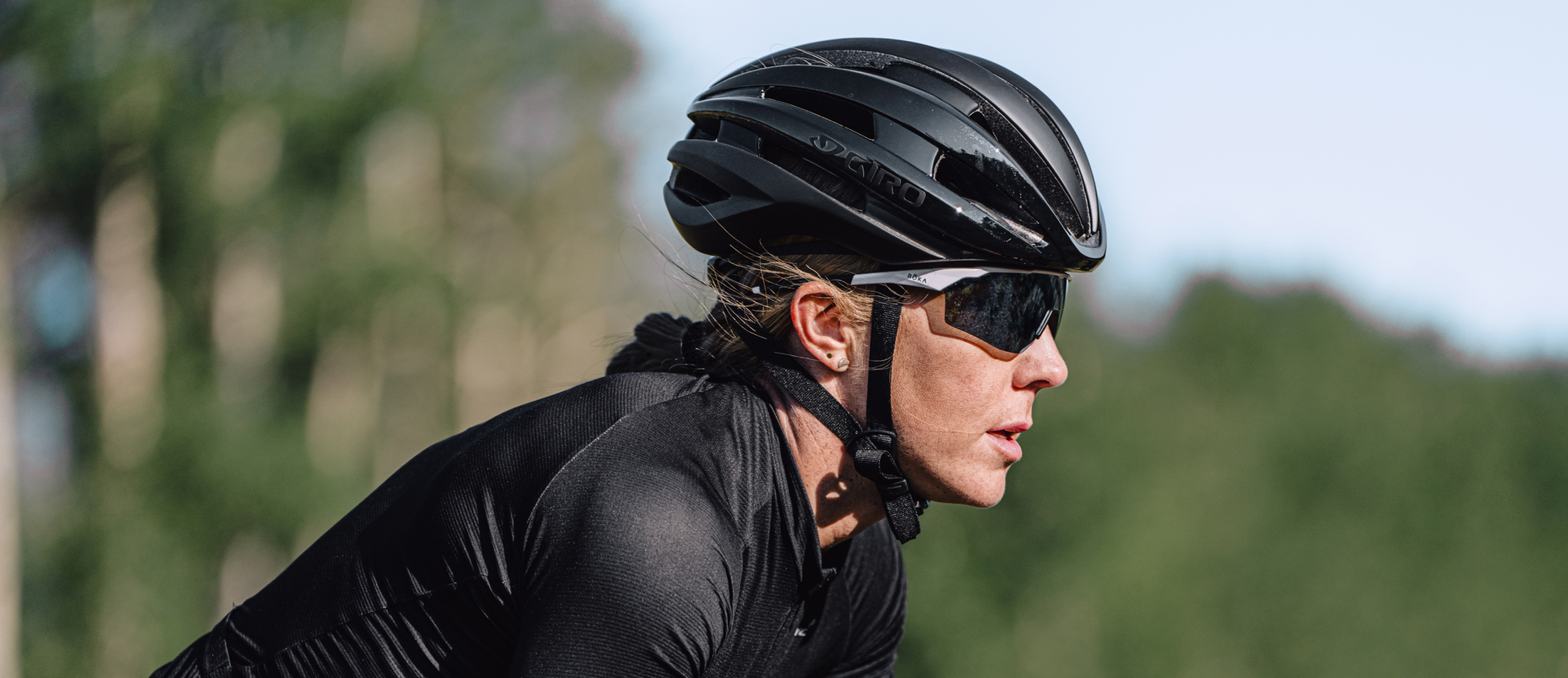 Woman in black cycling gear and SR-1x sunglasses