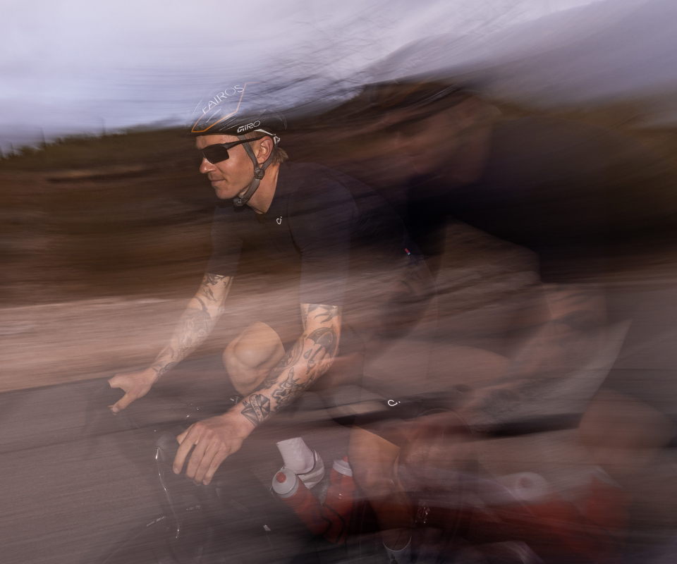 Man cycling wearing Tl-1 sunglasses