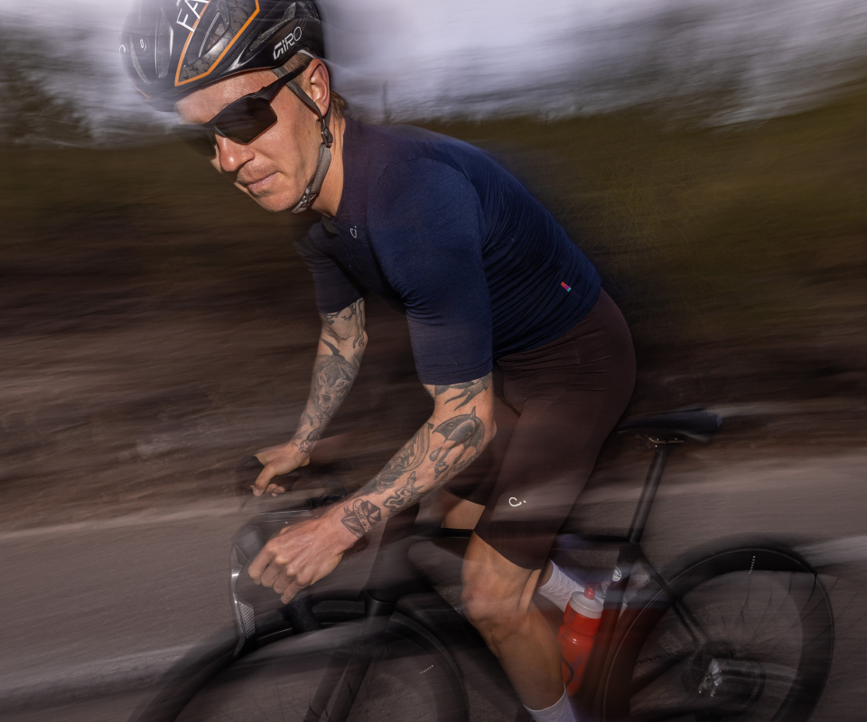 Man cycling wearing Tl-1 sunglasses