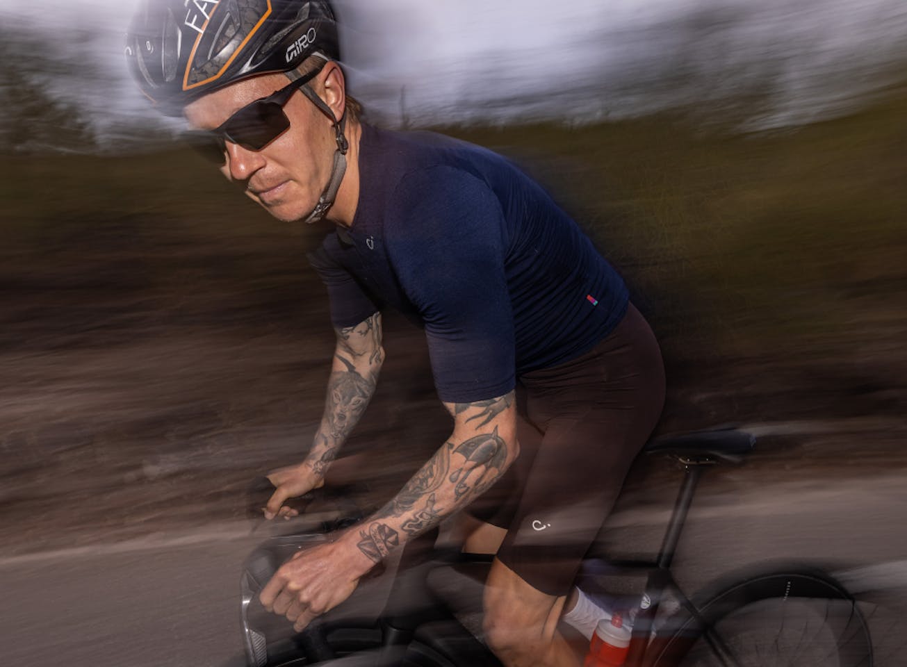 Man cycling wearing Tl-1 sunglasses