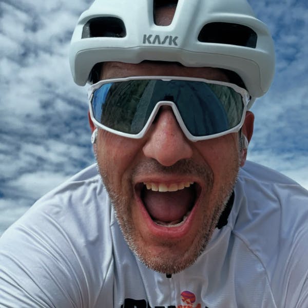 Man smiling wearing bike helmet and CP-1x sunglasses