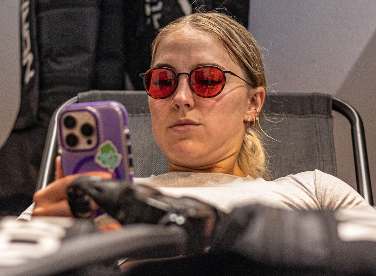 Woman wearing Alto Fusion glasses looking at phone