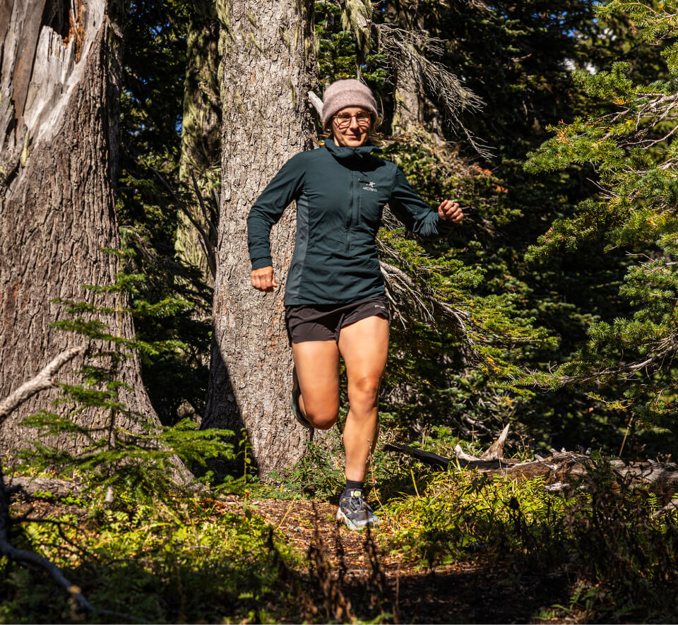 Woman running in woods wearing in Alto Fusion glasses