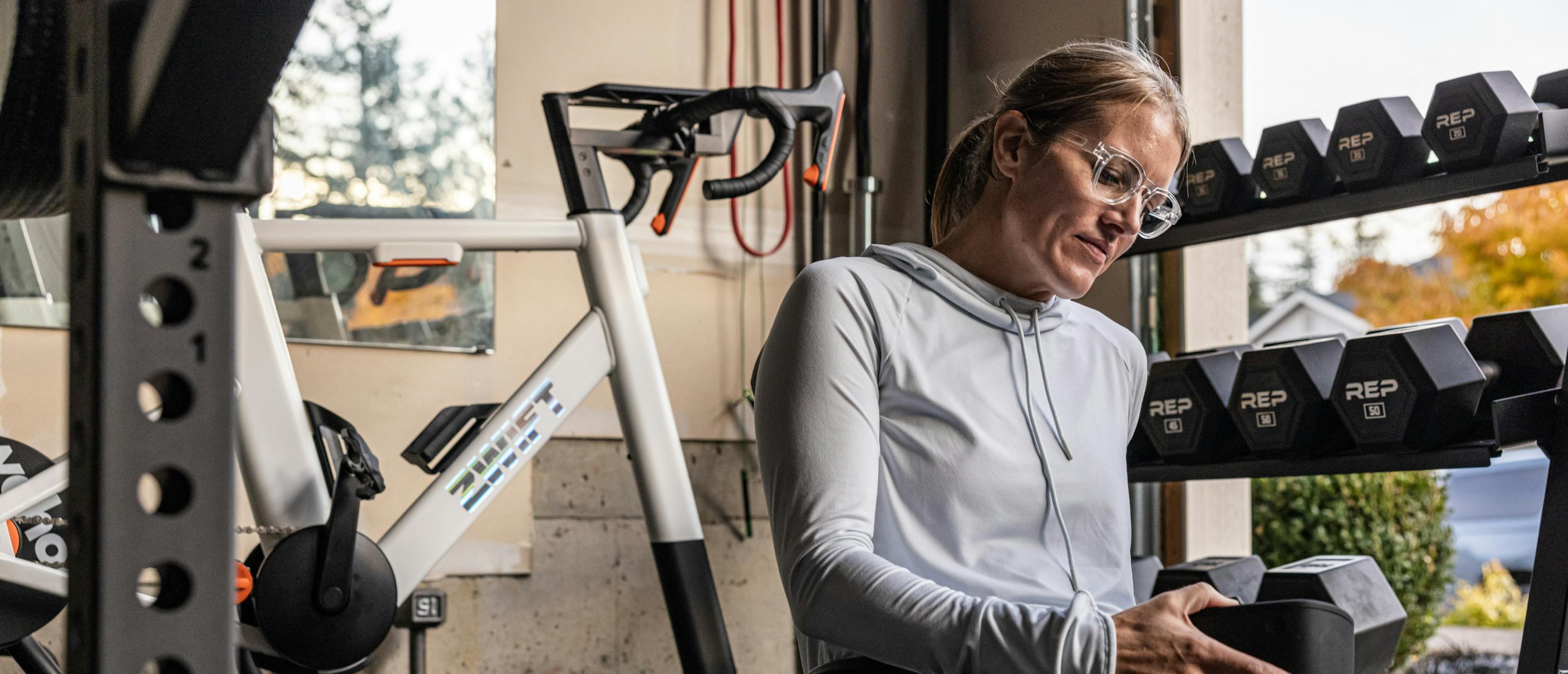 Woman grabbing dumbbell wearing Jackson eyeglasses