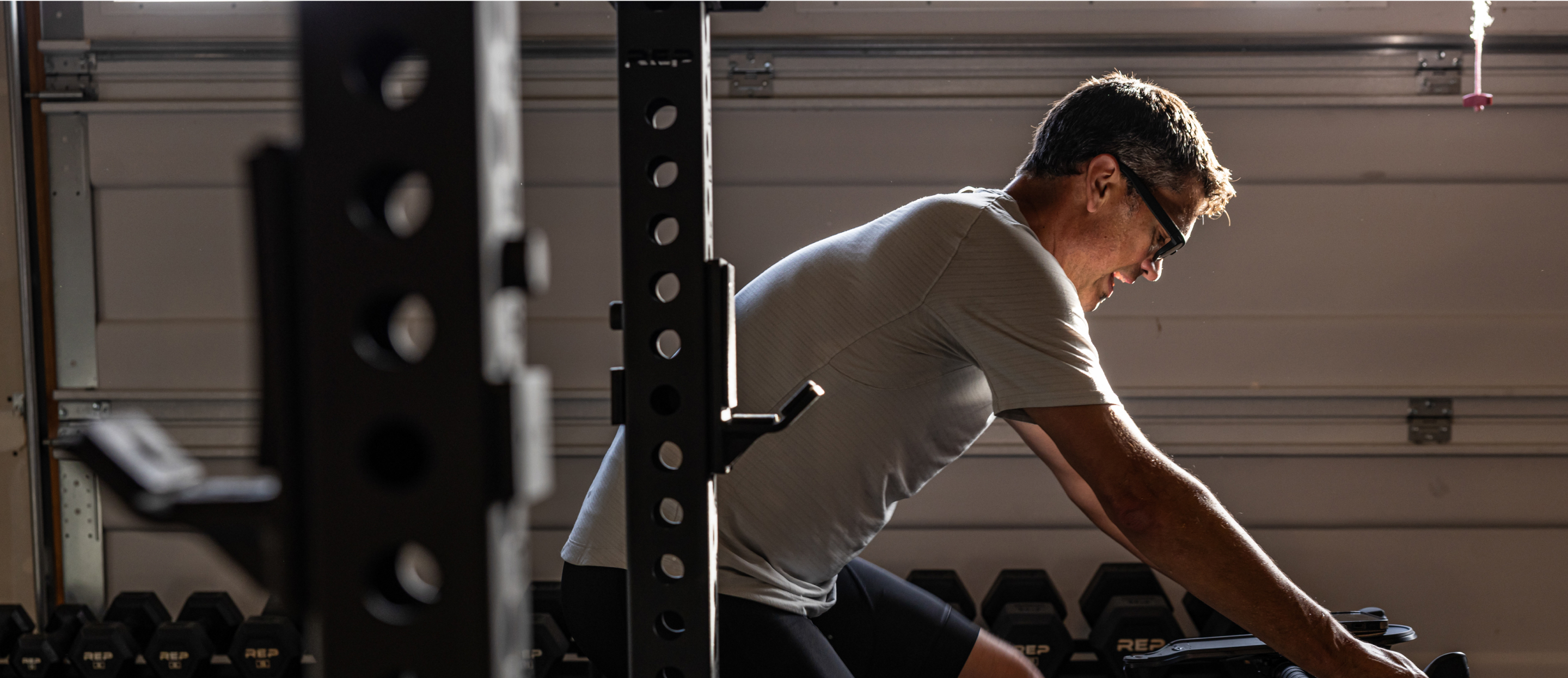 Man on stationary bike wearing Jackson eyeglasses