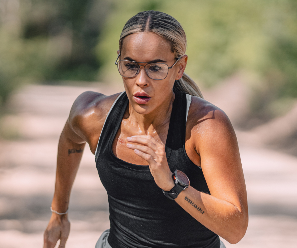 Woman running on trail wearing Falcon eyeglasses