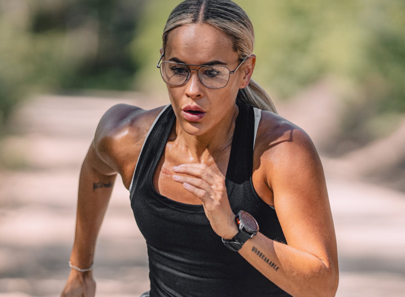 Woman running on trail wearing Falcon eyeglasses