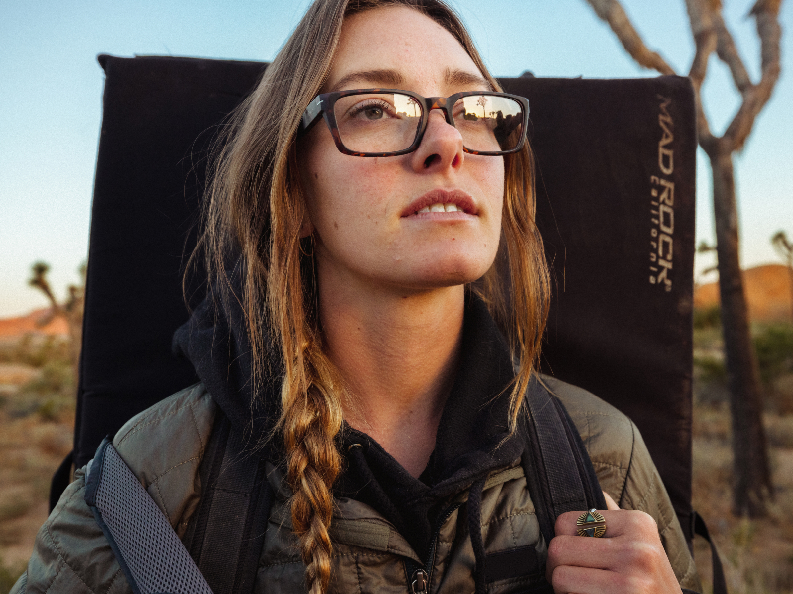 Woman carrying crash pad in Mayfield eyeglasses