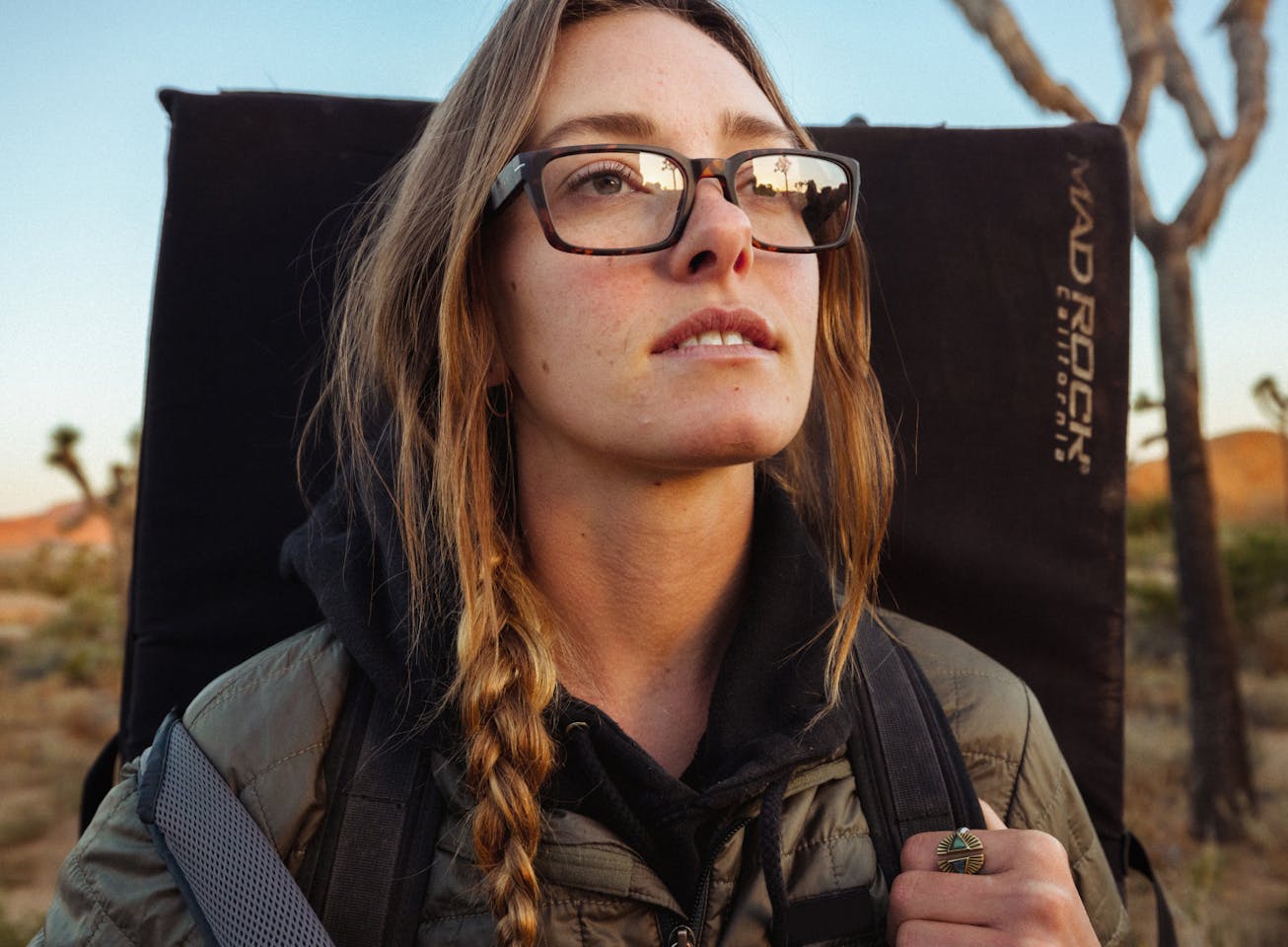 Woman carrying crash pad in Mayfield eyeglasses