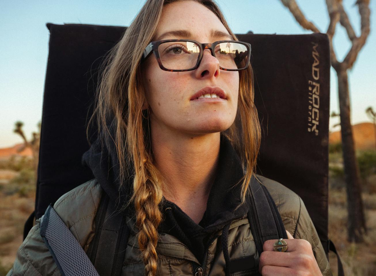 Woman carrying crash pad in Mayfield eyeglasses