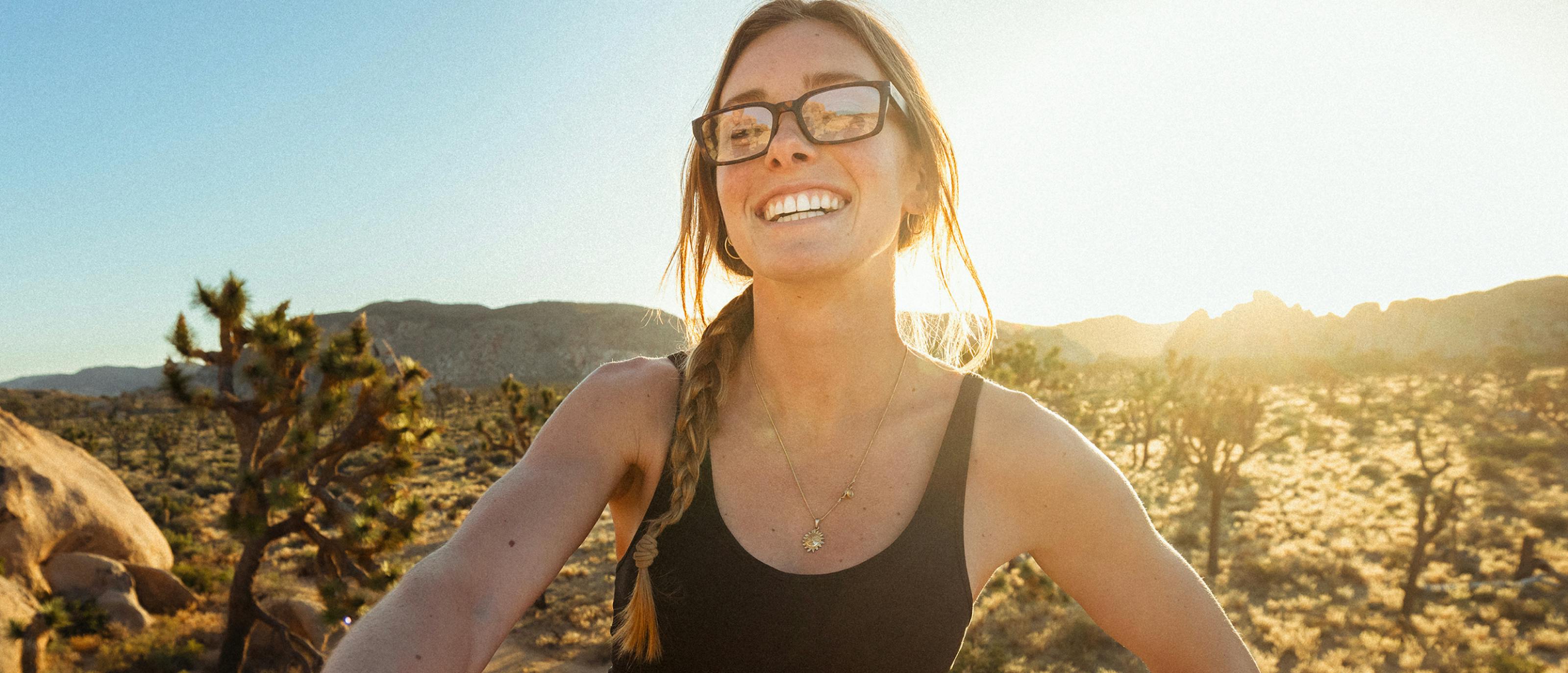 Woman smiling in desert wearing Mayfield eyeglasses