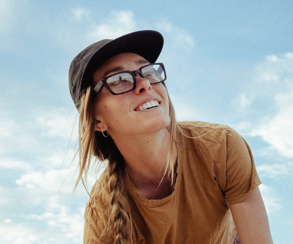 Woman wearing black hat and mayfield eyeglasses