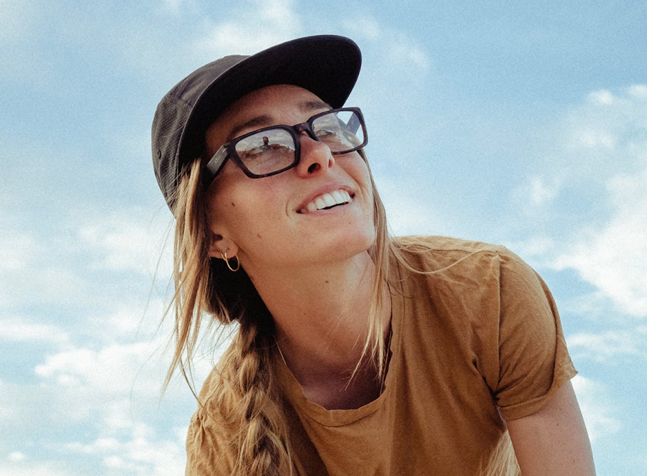 Woman wearing black hat and mayfield eyeglasses