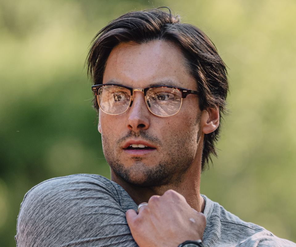 Man stretching wearing Cambridge eyeglasses