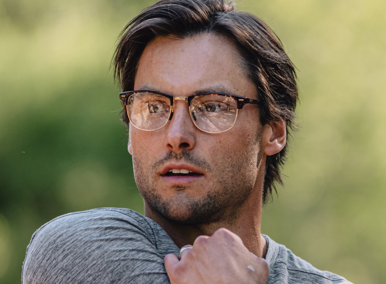 Man stretching wearing Cambridge eyeglasses