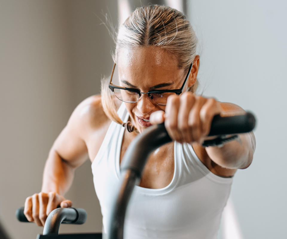 Woman riding assault bike wearing Cambridge Eyeglasses