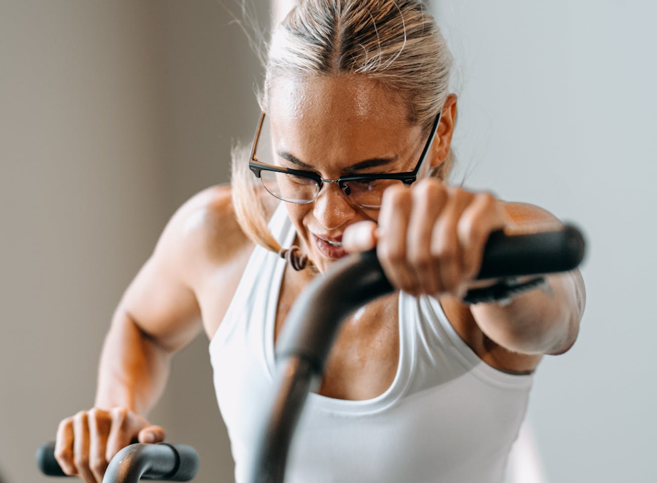 Woman riding assault bike wearing Cambridge Eyeglasses