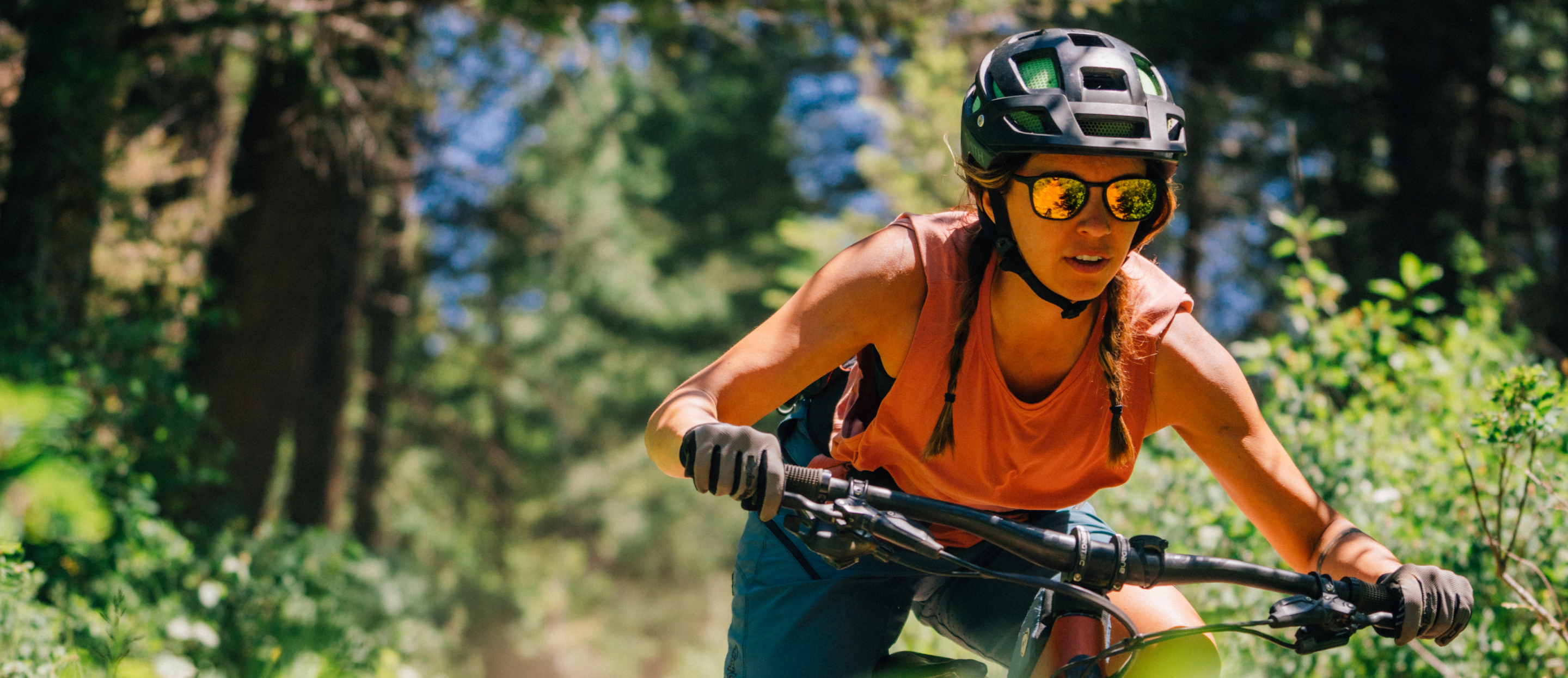 Woman mountain biking wearing Rory sunglasses