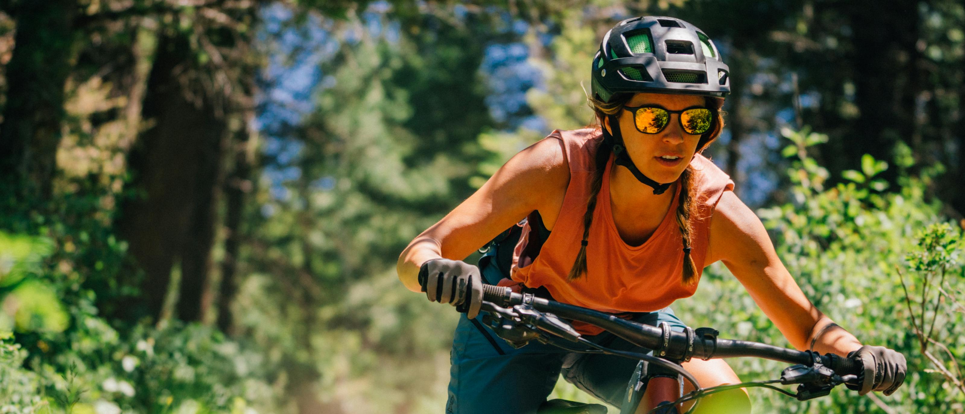 Woman mountain biking wearing Rory sunglasses