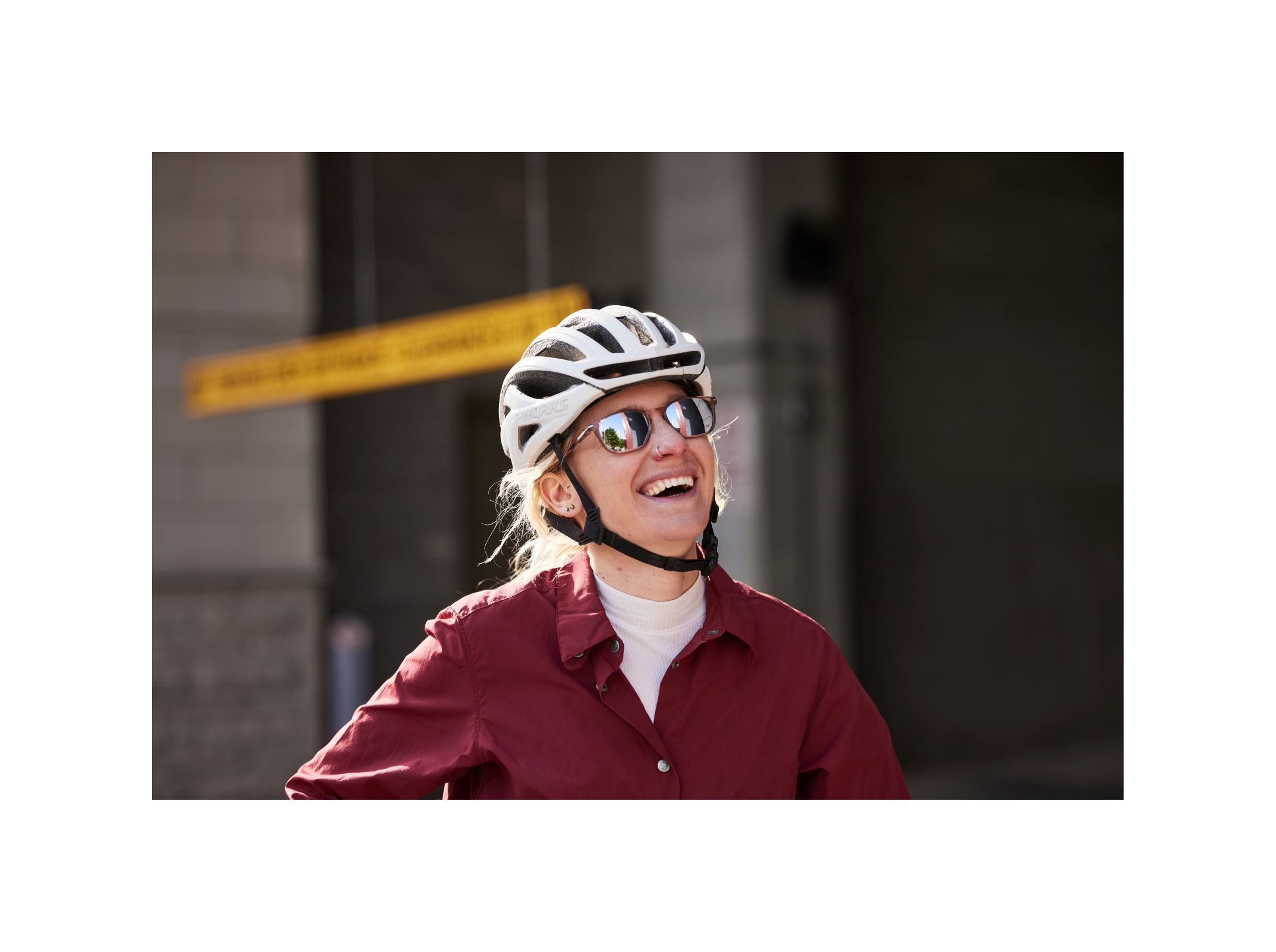Woman smiling on bike wearing Cade Sunglasses