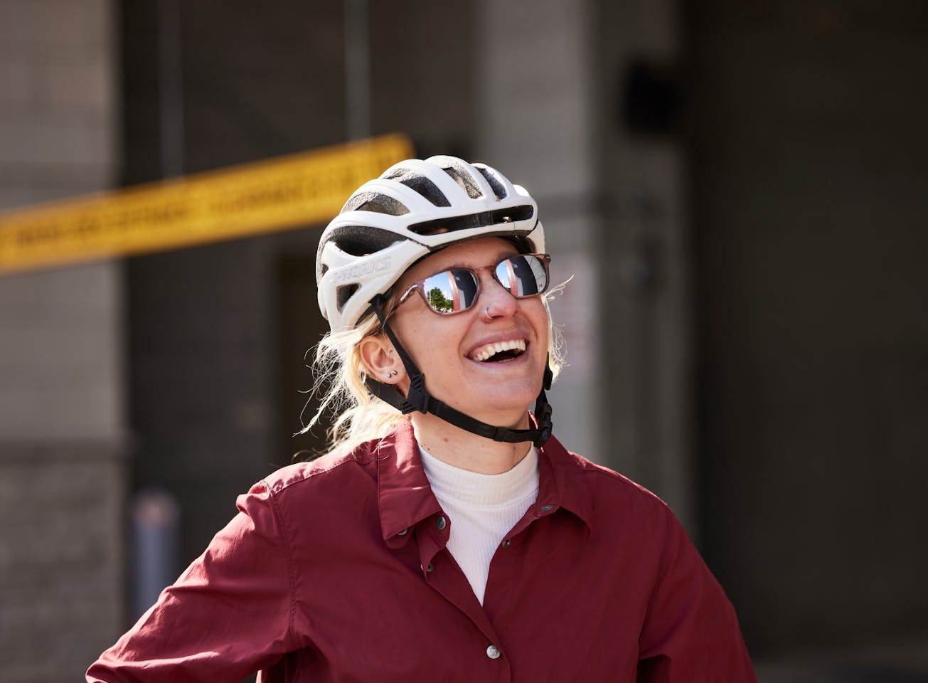 Woman smiling on bike wearing Cade Sunglasses
