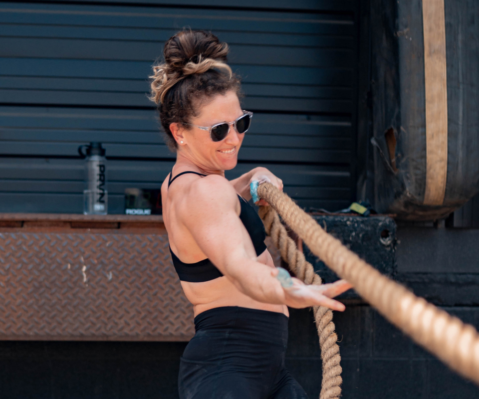 Woman pulling rope wearing Hunter sunglasses