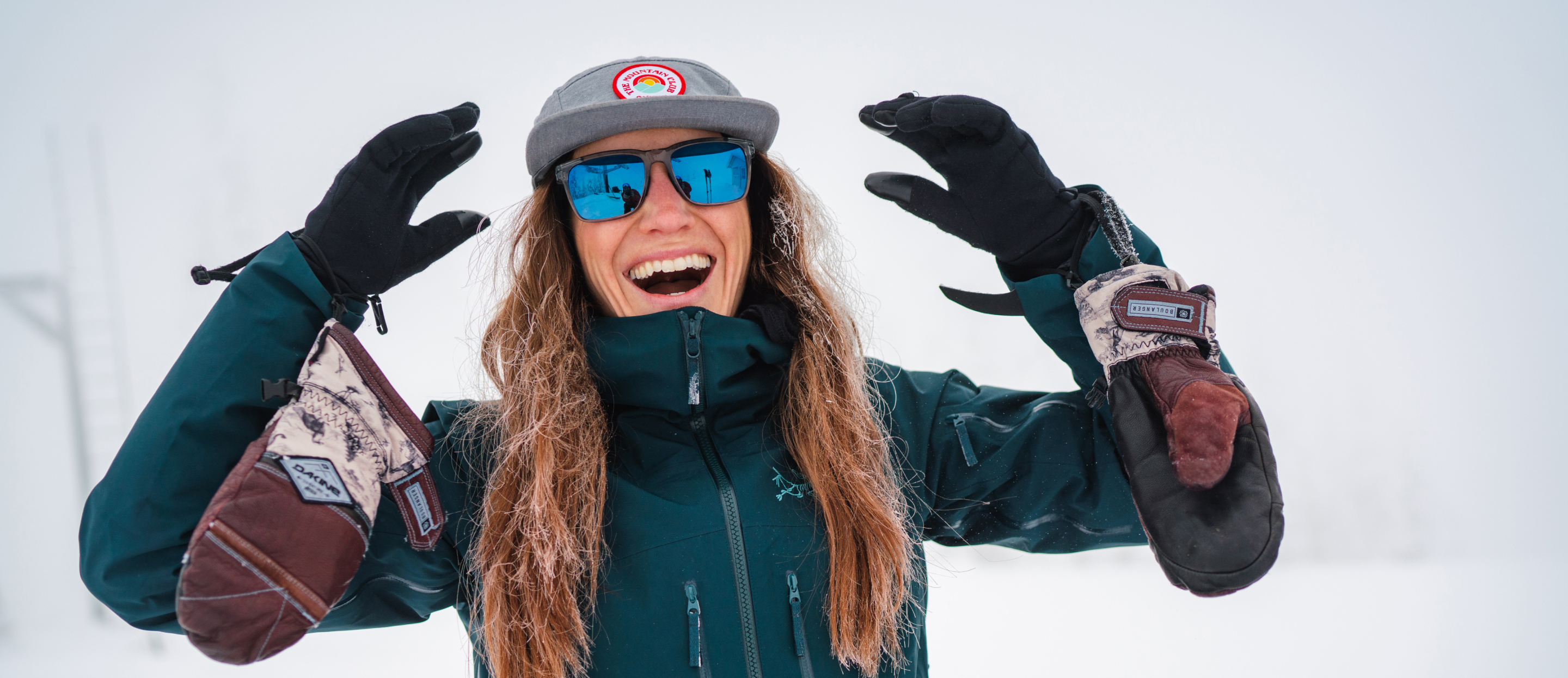 Woman smiling in the snow wearing Barton sunglasses