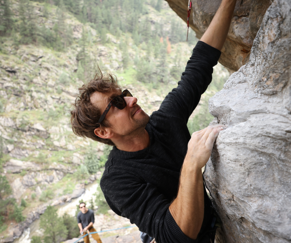 Man bouldering wearing Lockhart Sunglasses
