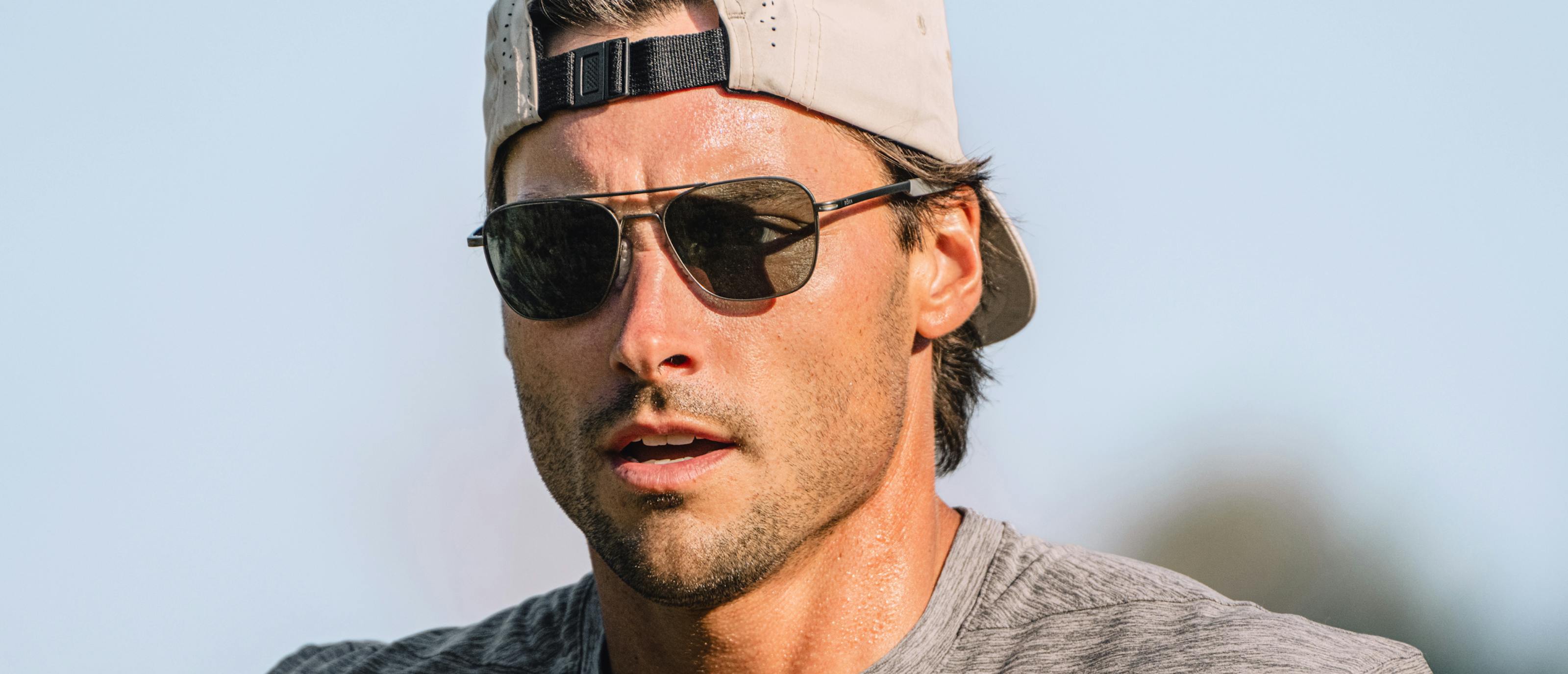 Man wearing backwards hat and Falcon sunglasses