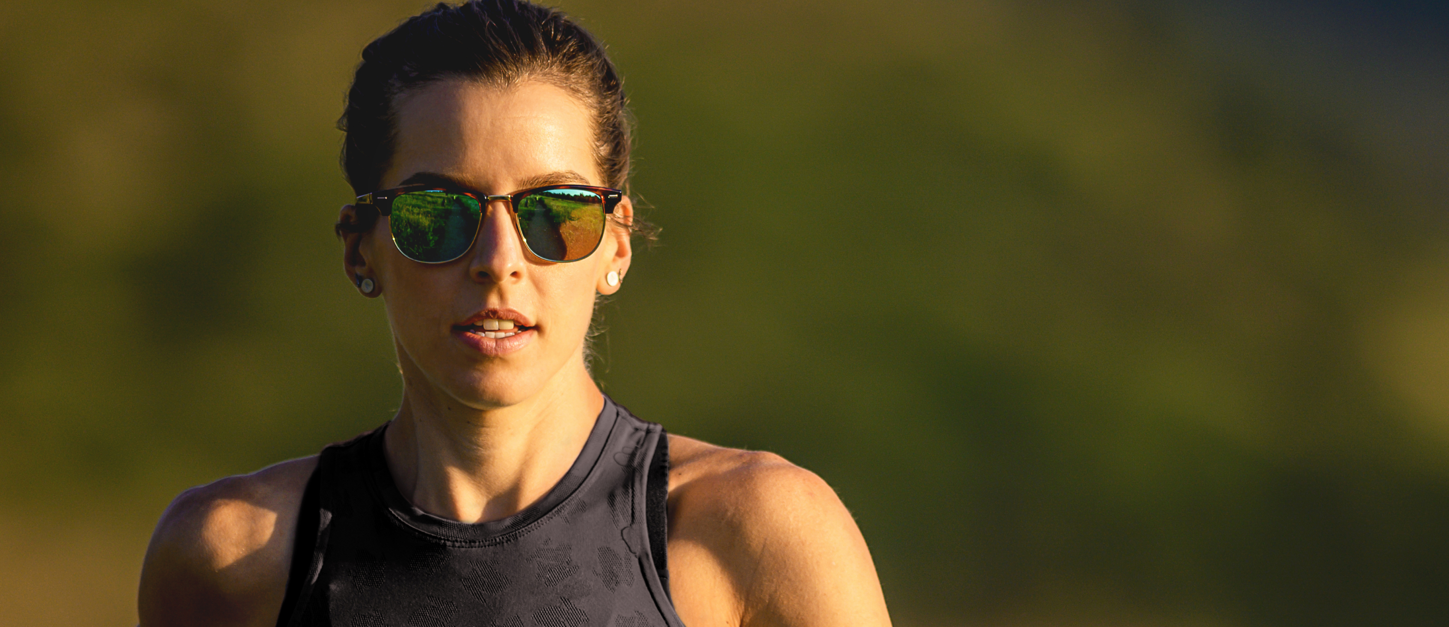 Woman wearing black tank top and Cambridge sunglasses