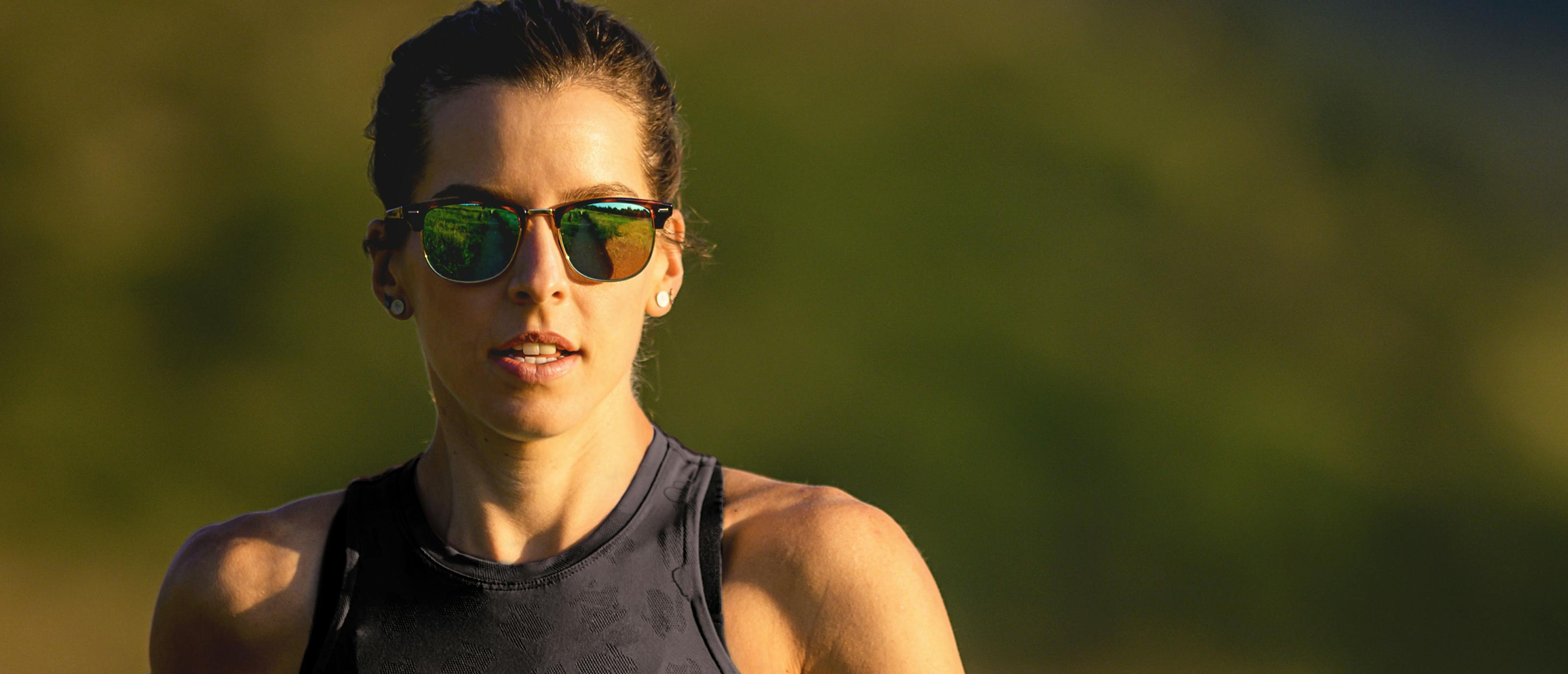 Woman wearing black tank top and Cambridge sunglasses