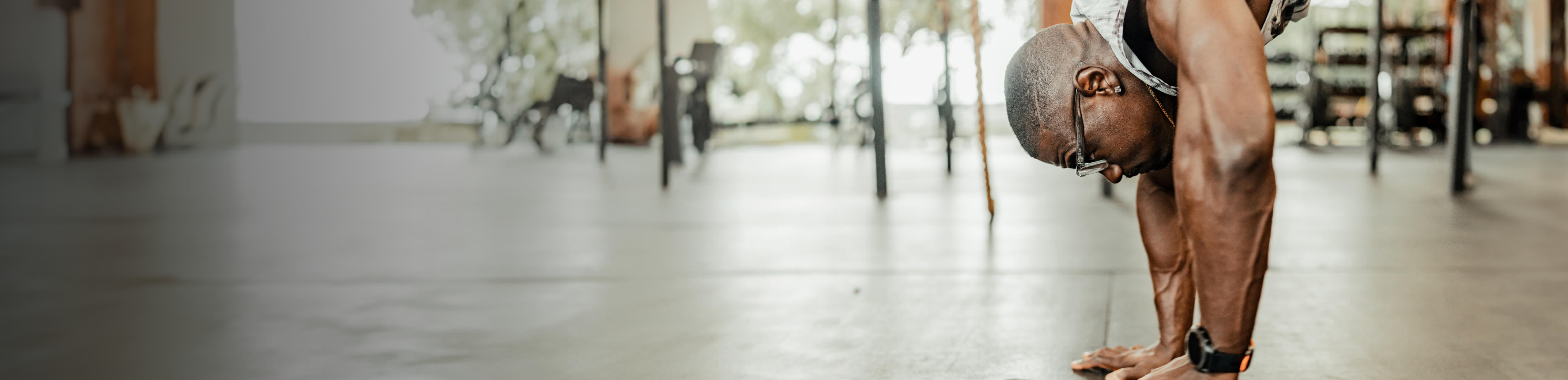 Man hanging upside down in Barton glasses