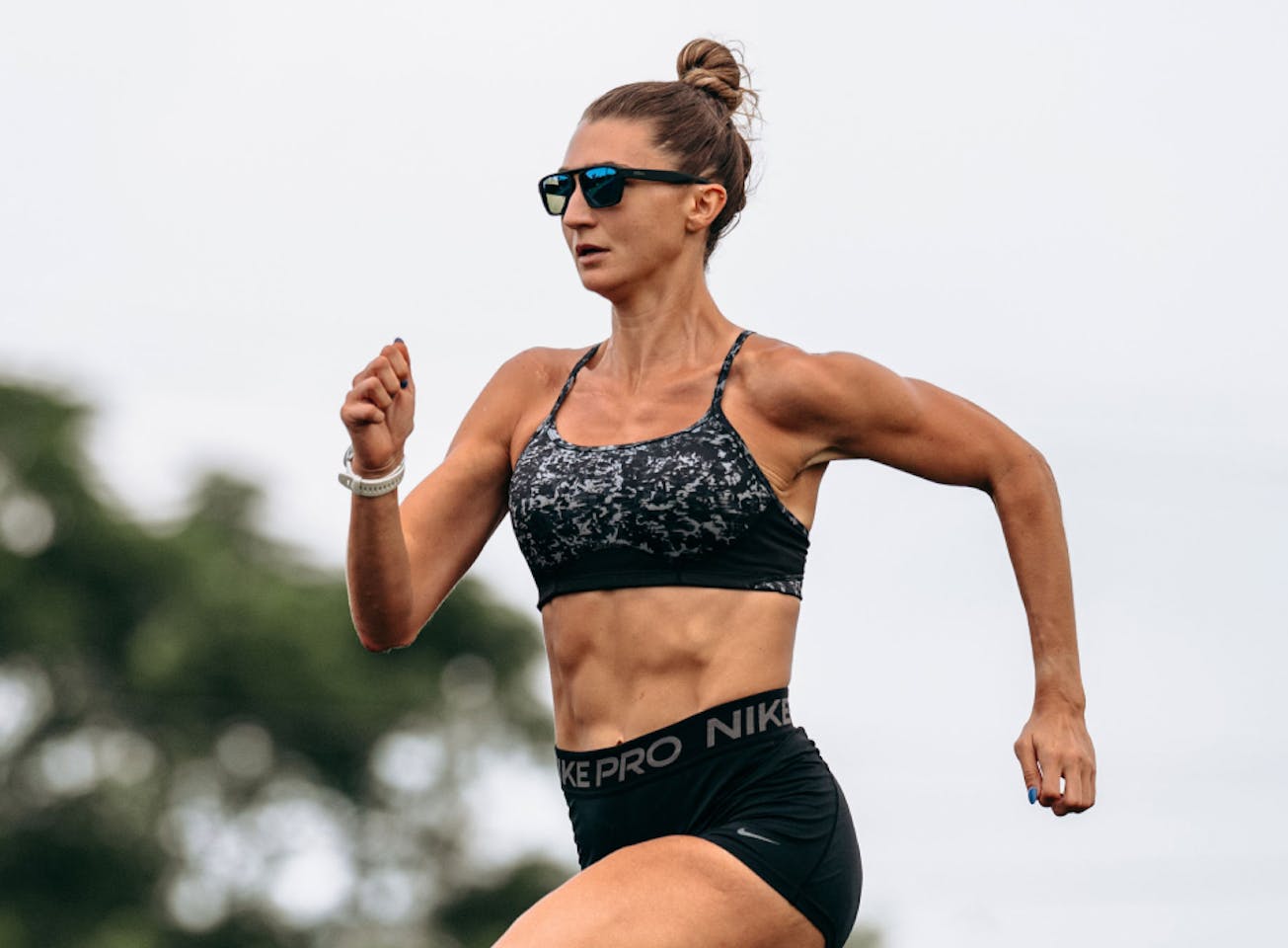 Woman sprinting wearing Estacado sunglasses
