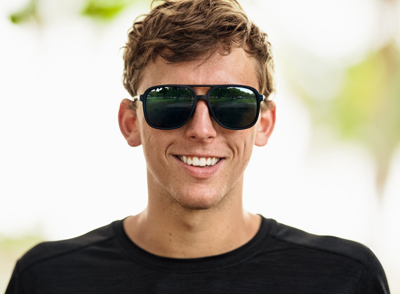 Man smiling outside in Bandera Sunglasses